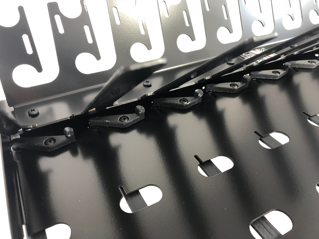 Each bay has a spring loaded mechanical toggle for power button actuation